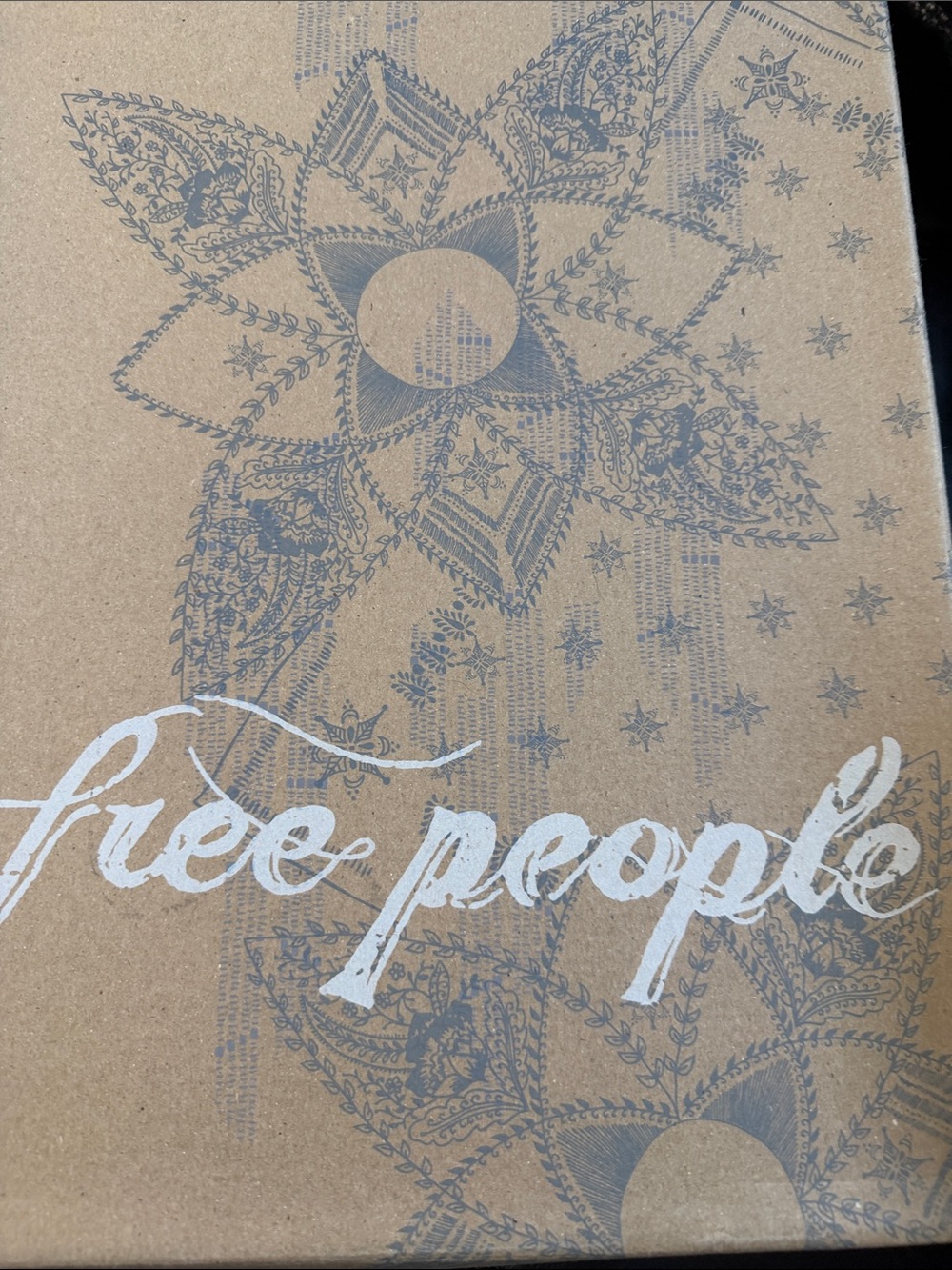 Free People White Logo on Kraft Box with Blue-Gray Floral Print